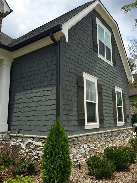 grey house with brown metal roof|gray exterior with black trim.